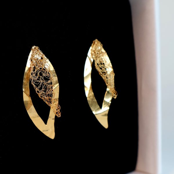 Boucles d'oreilles Folÿs 5 dans leur boîte à bijou haut de gamme blanche et sa mousse noire, révélant l'éclat doré du métal.